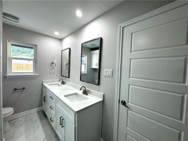 bathroom featuring vanity and toilet