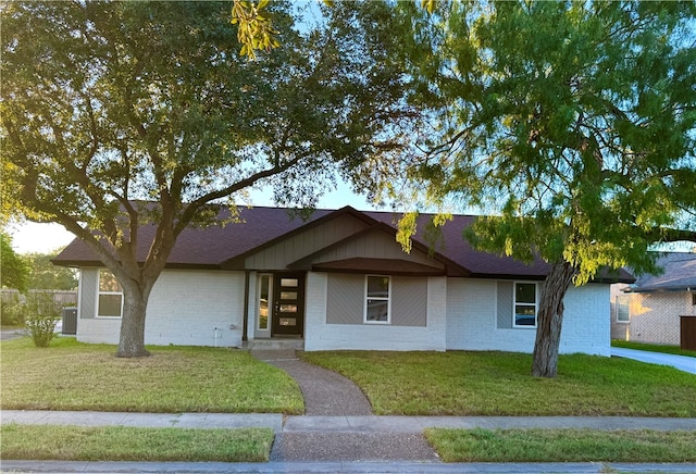 ranch-style home with a front lawn