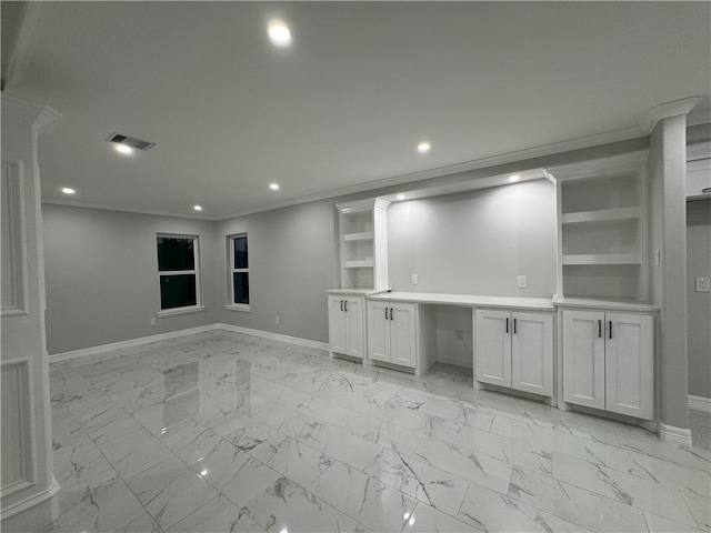 interior space with built in shelves and ornamental molding