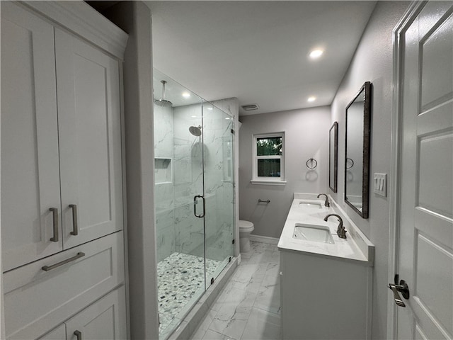 bathroom with vanity, toilet, and a shower with door