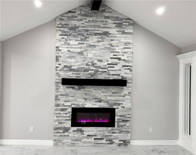 details with a tile fireplace and beamed ceiling