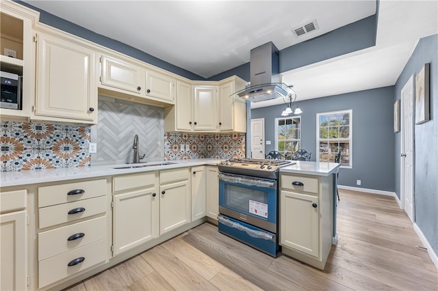 kitchen with sink, ventilation hood, light hardwood / wood-style flooring, cream cabinetry, and electric stove