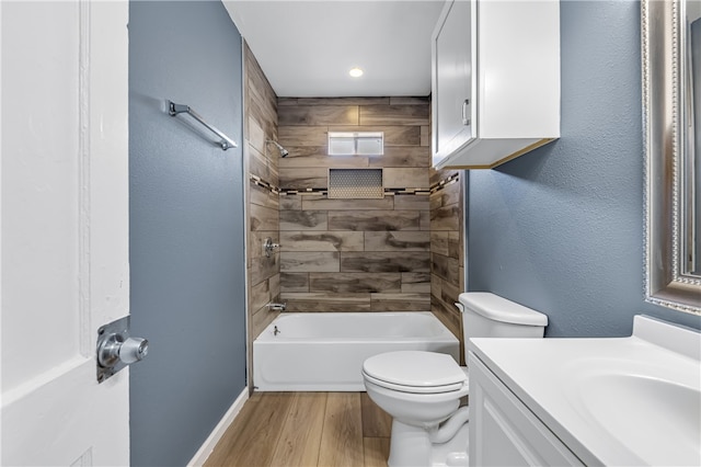 full bathroom with tiled shower / bath, vanity, toilet, and hardwood / wood-style flooring