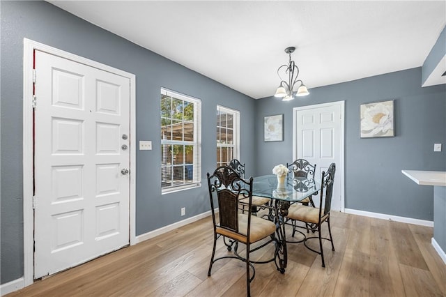 3609 Stinson St, Corpus Christi, TX 78405 - dining room featuring light wood-style floors, a chandelier, and baseboards