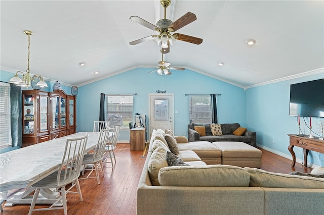 living room with dark wood-type flooring, ceiling fan, vaulted ceiling, and ornamental molding