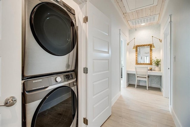 1901 Eskridge Rd, Port Aransas, TX 78373 - washroom with attic access, stacked washing machine and dryer, baseboards, and light wood-style flooring