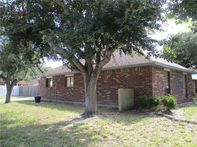 view of side of home with a lawn