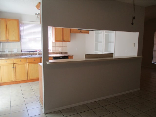 kitchen with light brown cabinetry, tasteful backsplash, light tile patterned floors, and sink