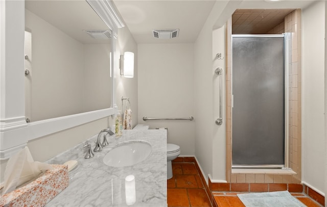 bathroom with toilet, vanity, an enclosed shower, and tile patterned flooring