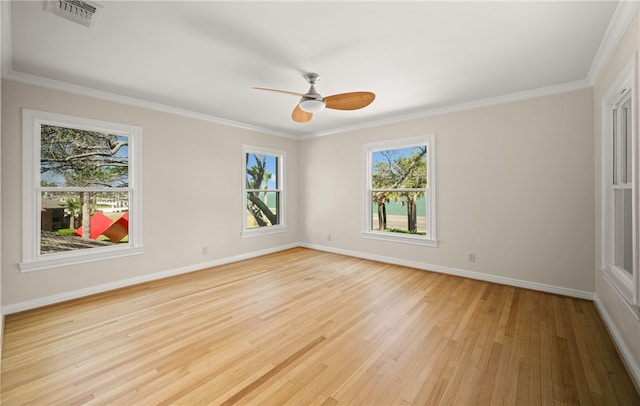 spare room featuring ornamental molding, light hardwood / wood-style flooring, and ceiling fan