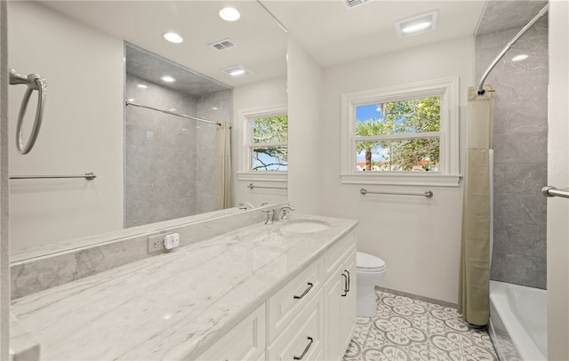 full bathroom featuring toilet, shower / bath combo, vanity, and tile patterned floors