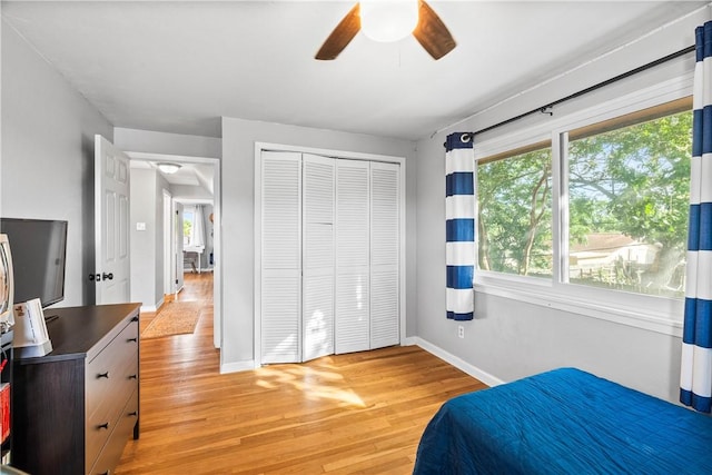 5830 Woodhaven Dr, Corpus Christi, TX 78412 - bedroom featuring multiple windows, light wood-type flooring, a closet, and ceiling fan