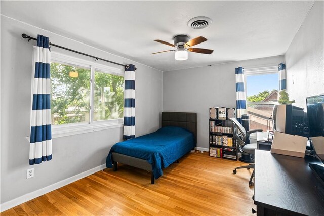 5830 Woodhaven Dr, Corpus Christi, TX 78412 - bedroom featuring wood finished floors, an office area, and a ceiling fan
