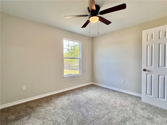 carpeted spare room with ceiling fan