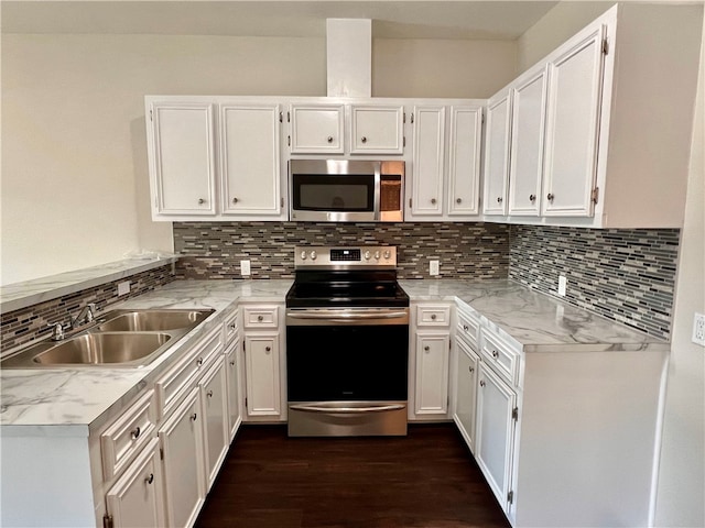 kitchen featuring white cabinets, stainless steel appliances, sink, and tasteful backsplash