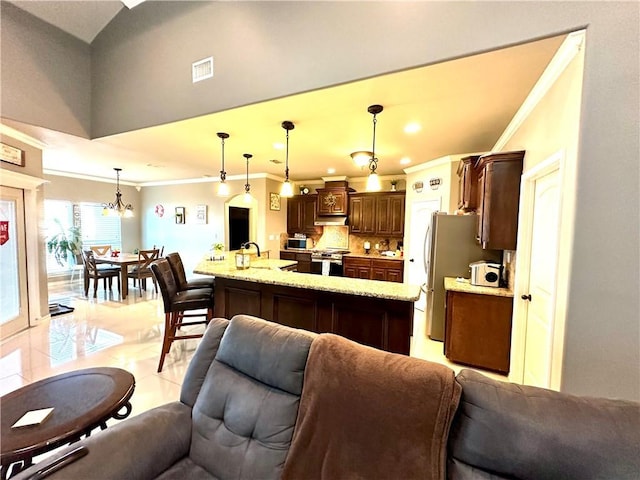 kitchen featuring crown molding, stainless steel appliances, dark brown cabinetry, light tile patterned flooring, and decorative light fixtures