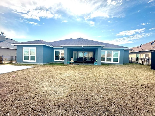 rear view of house featuring a yard