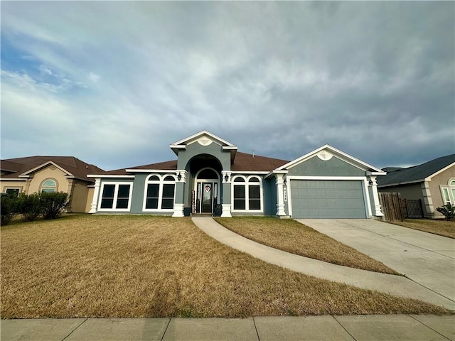 ranch-style house featuring a garage and a front yard