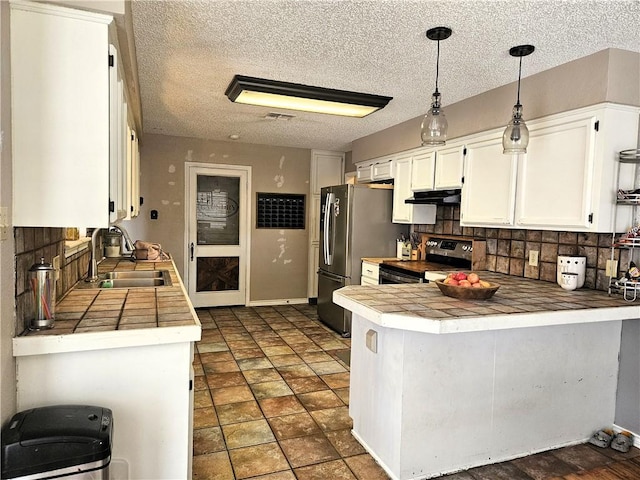 5317 Tartan, Corpus Christi, TX 78413 - kitchen with appliances with stainless steel finishes, a sink, under cabinet range hood, white cabinetry, and a peninsula