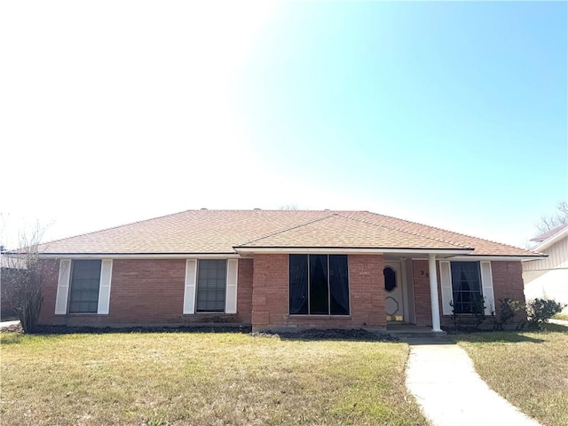 230 Terlingua Dr, Portland, TX 78374 - ranch-style home featuring a front lawn, a shingled roof, and brick siding