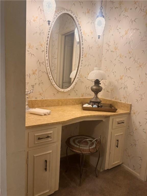 bathroom featuring wallpapered walls, baseboards, and vanity