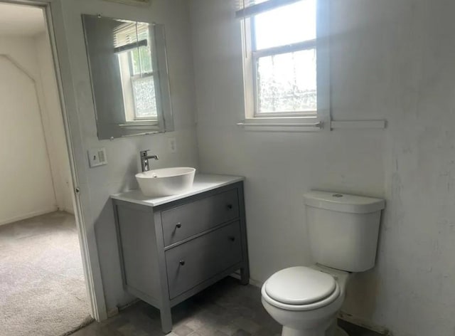 bathroom with toilet and vanity