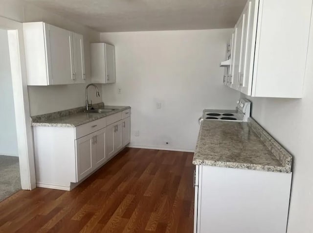 kitchen featuring electric range, dark hardwood / wood-style floors, sink, and white cabinetry