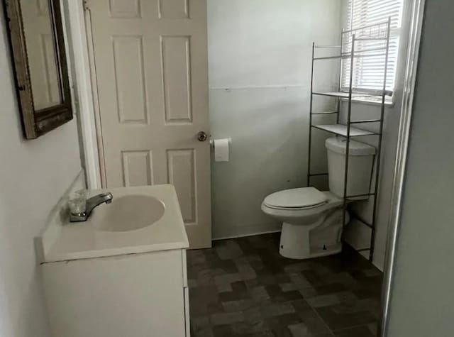 bathroom featuring toilet and vanity