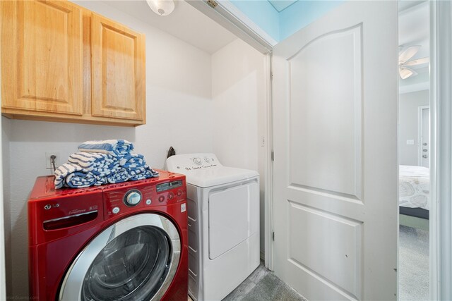 washroom with washer and clothes dryer, cabinets, and ceiling fan