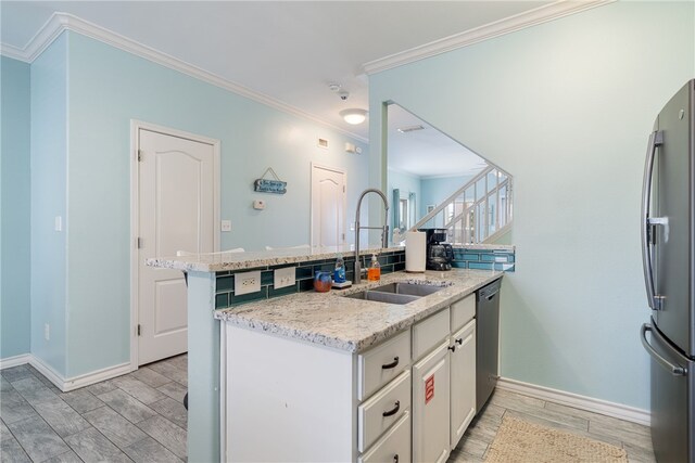 kitchen featuring stainless steel appliances, white cabinetry, sink, and kitchen peninsula