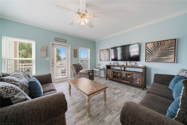 living room with ornamental molding, light hardwood / wood-style floors, a healthy amount of sunlight, and ceiling fan