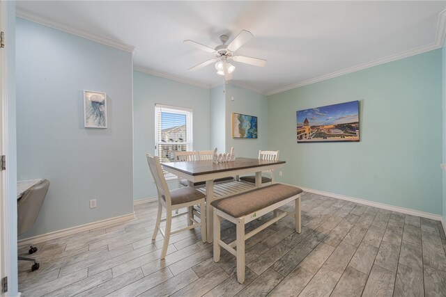 dining room featuring light wood-type flooring, ceiling fan, and crown molding