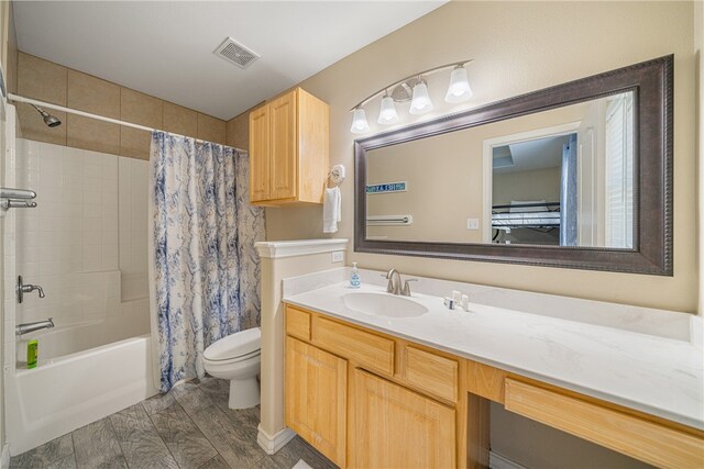 full bathroom with toilet, shower / tub combo with curtain, vanity, and hardwood / wood-style flooring