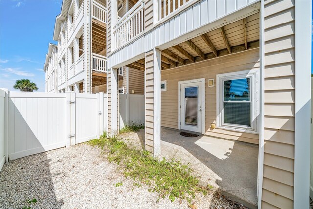 view of exterior entry with a patio