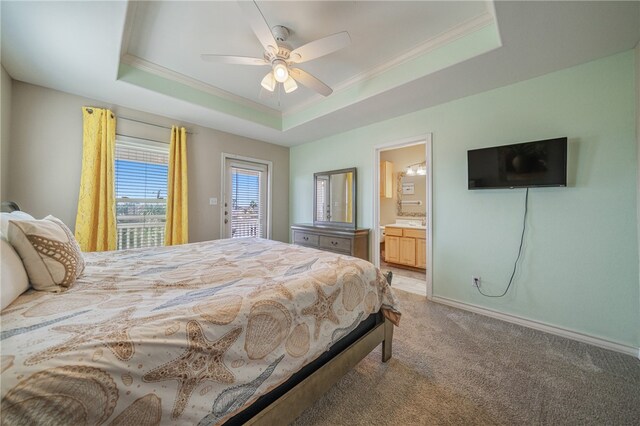 bedroom featuring carpet flooring, ensuite bath, ceiling fan, and a tray ceiling