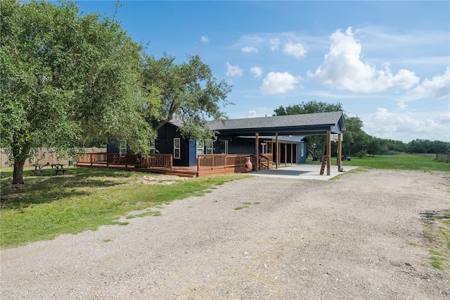 view of front of home with a front yard and a wooden deck