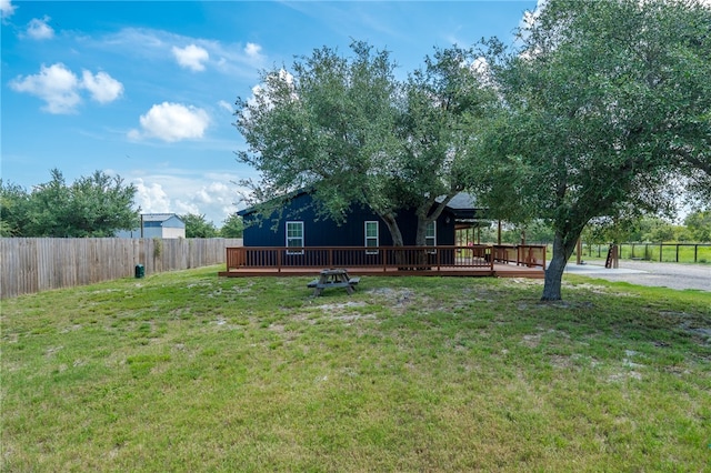 exterior space featuring a wooden deck and a front yard