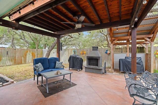 view of patio / terrace featuring a grill, an outdoor living space with a fireplace, and ceiling fan