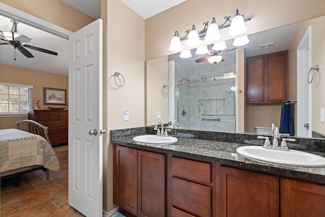 bathroom with vanity, ceiling fan, and a shower with shower door