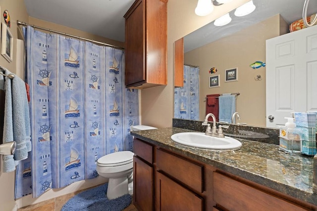 bathroom with vanity, tile patterned flooring, and toilet