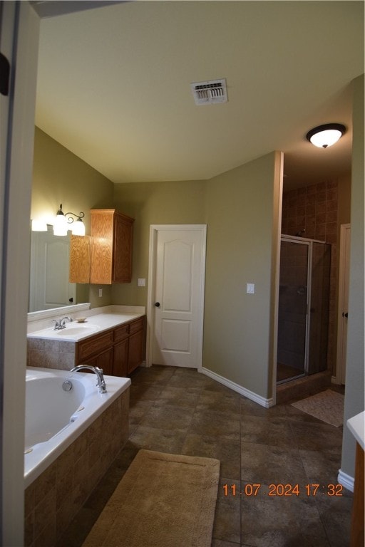 bathroom with independent shower and bath, tile patterned flooring, and vanity