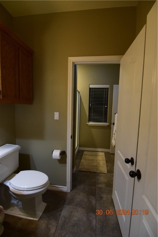 bathroom with tile patterned floors and toilet