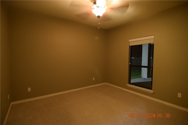 spare room with carpet and ceiling fan