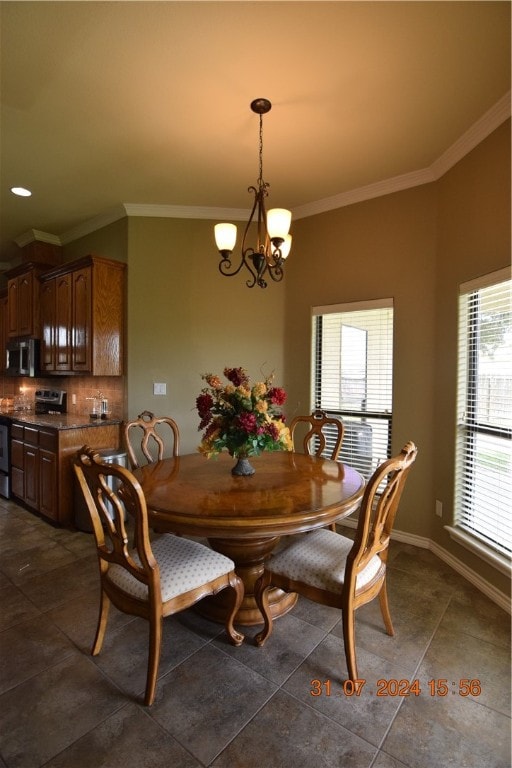 tiled dining space featuring a chandelier, a healthy amount of sunlight, and crown molding