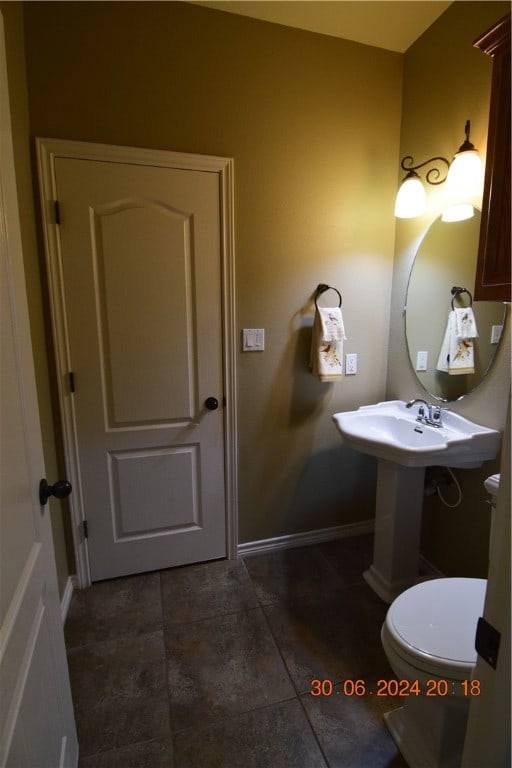 bathroom featuring toilet and tile patterned flooring