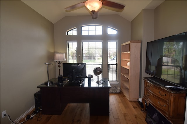 office space featuring ceiling fan, light wood-type flooring, and lofted ceiling