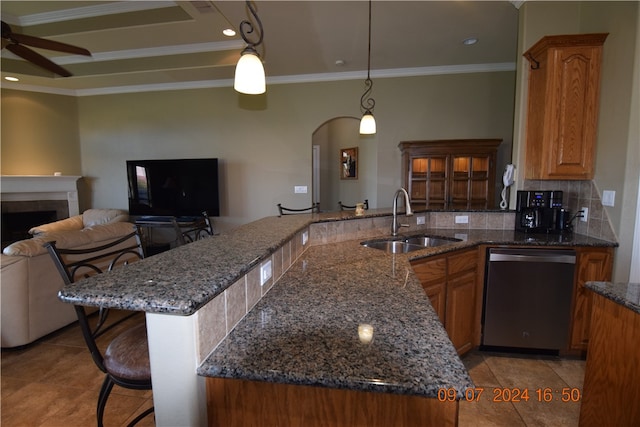 kitchen with a kitchen bar, pendant lighting, decorative backsplash, sink, and dishwasher