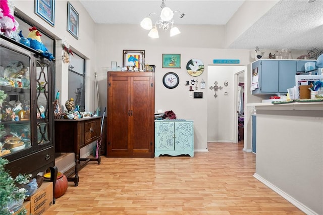 interior space with a chandelier and light hardwood / wood-style flooring