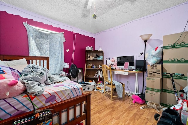 bedroom featuring hardwood / wood-style floors and a textured ceiling