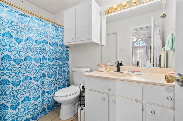 bathroom featuring tile patterned floors, toilet, a textured ceiling, vanity, and ceiling fan